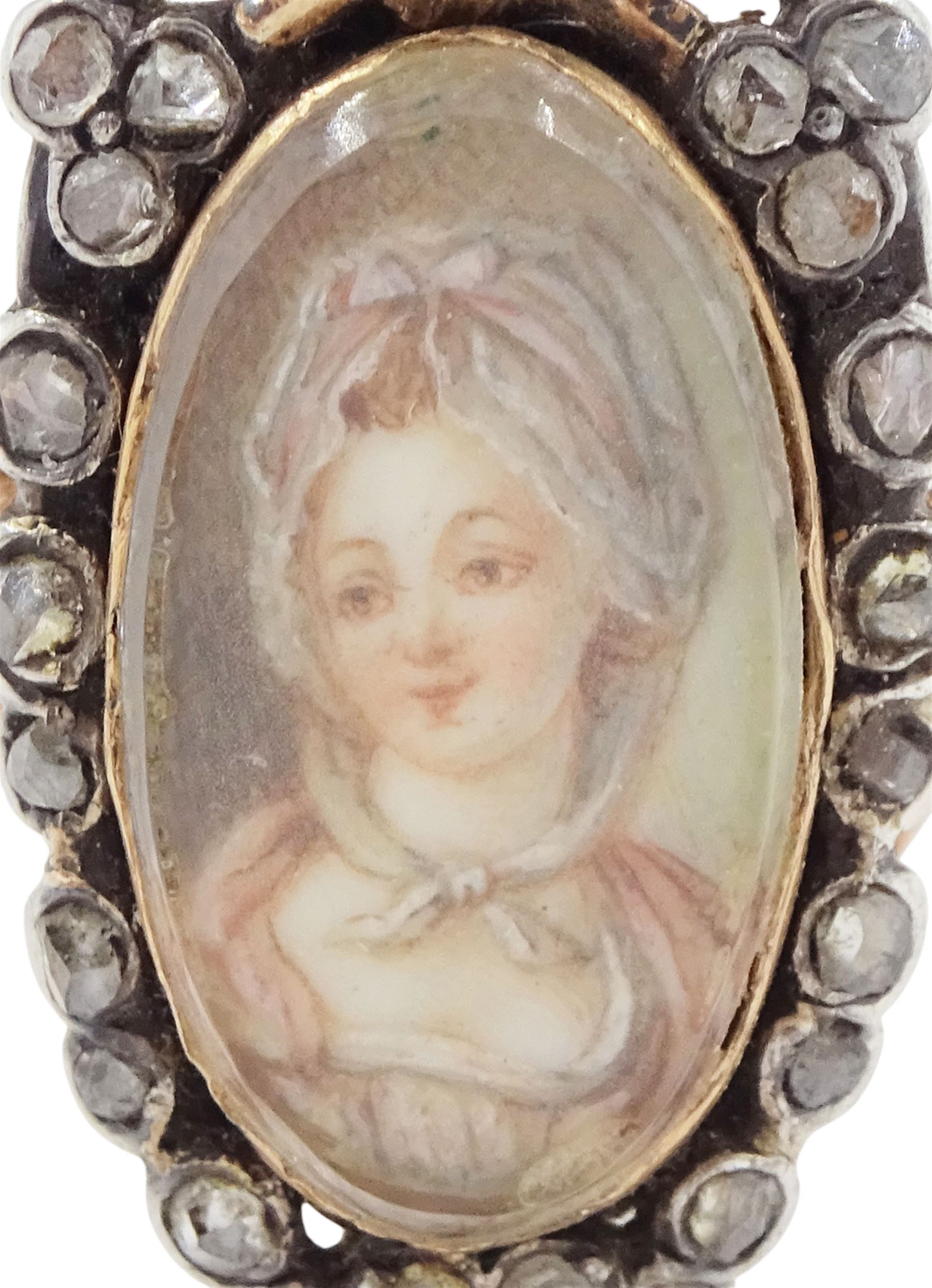 18th / 19th century silver and gold diamond and sapphire portrait ring, set with an oval miniature of a woman wearing a bonnet on ivory, under a glazed panel, surmounted with a 'trophy of love' symbol, modelled as a flaming torch and bow and quiver, set with a single round cut sapphire and rose cut diamond surround, to trifurcated shoulders, on French 18ct gold shank, Eagle hallmark. This lot has been registered for sale under Section 10 of the APHA Ivory Act