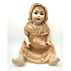 German bisque head doll with applied hair, sleeping eyes and open mouth with teeth and fixed tongue, on composition body with jointed limbs, marked 'P.M. 914 Germany 14' H65cm