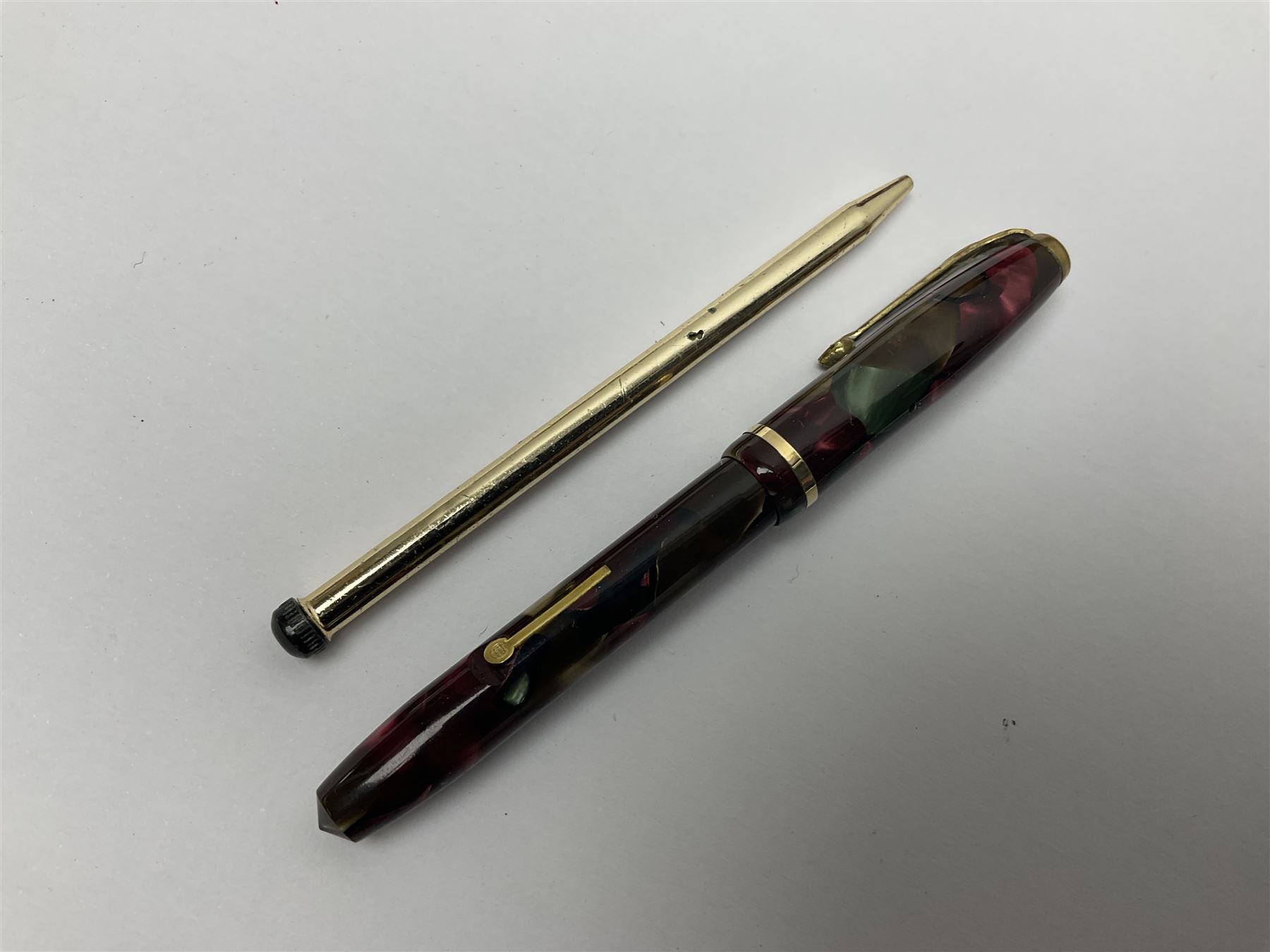 Three fountain pens, to include Conway Stewart 'Dinkie 550' and 'Conway 57' and a Parker 'Slimfold', all with 14ct gold nibs, together two roller ball pens, including a Parker example and a Swarovski Crystal paperweight