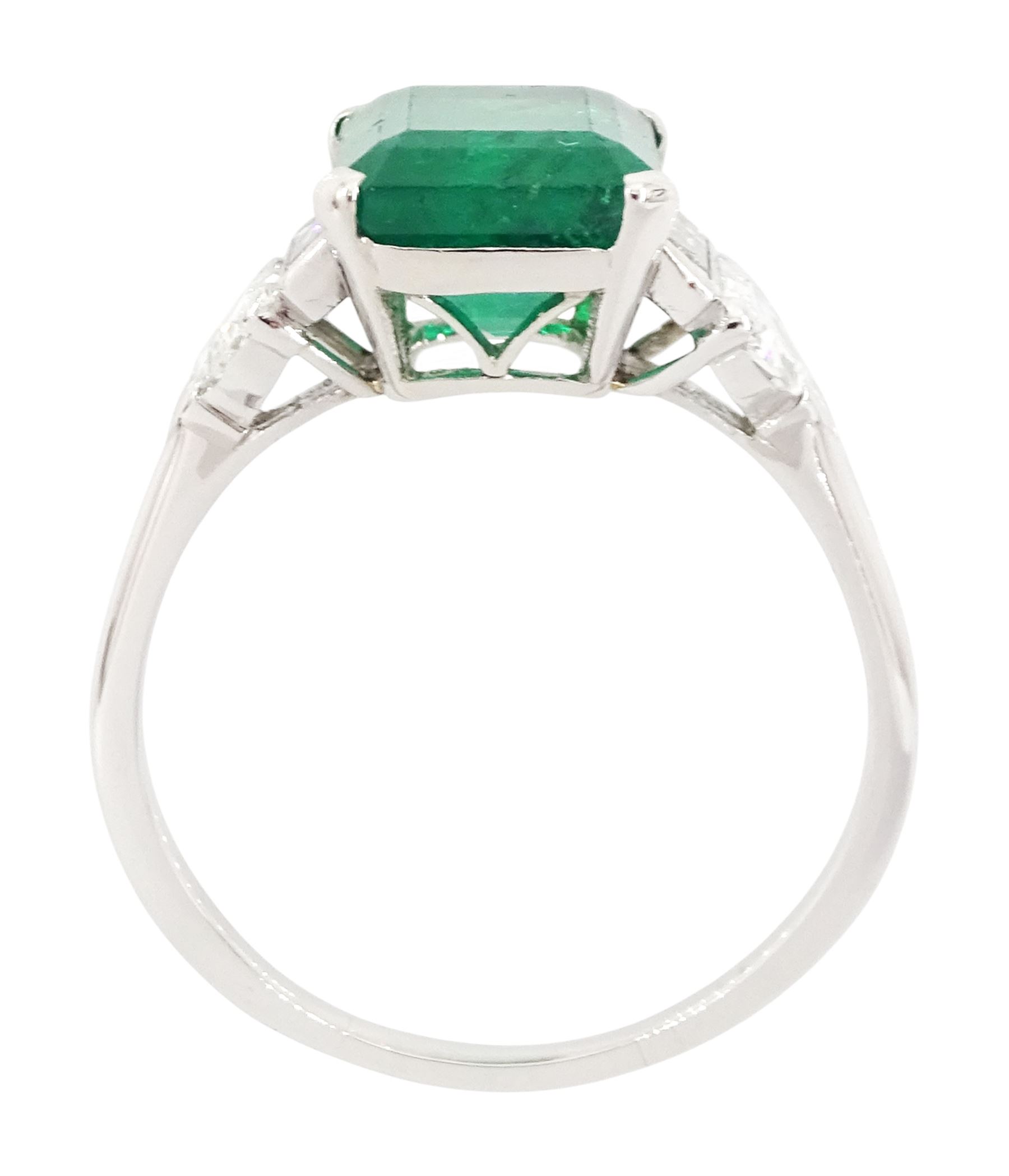 Platinum Colombian emerald and diamond ring, single emerald cut emerald of approx 3.00 carat, each side set with a single baguette cut and heptagonal cut diamond, with The Gem & Pearl Laboratory report