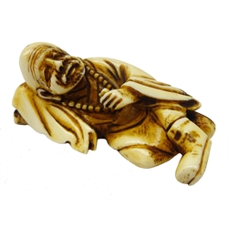  Japanese Meiji ivory Okimono modelled as a man laid, resting his head on a pillow, L7cm Provenance: private collection   