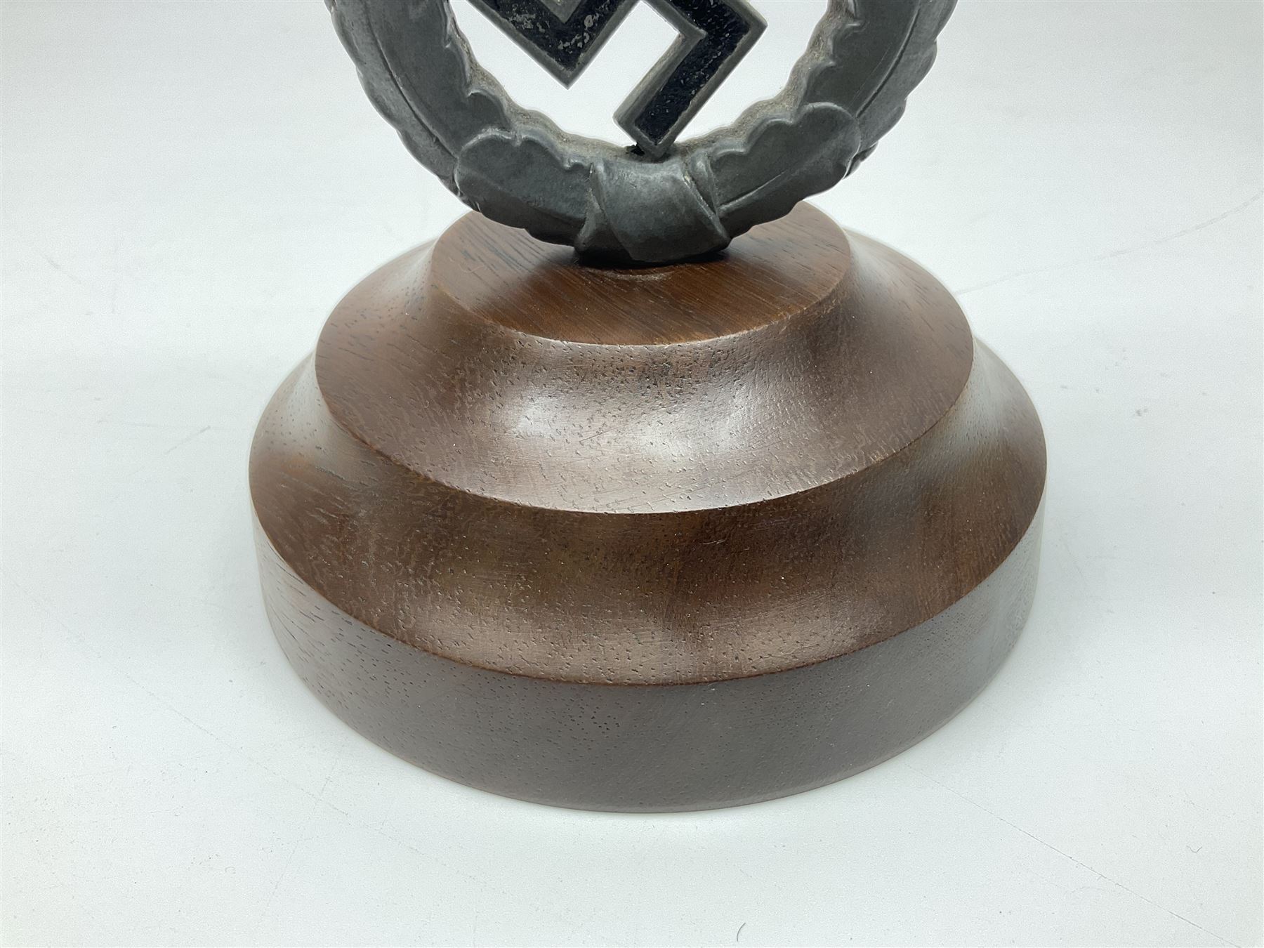 WW2 German cast white metal desk ornament/paperweight as the eagle insignia on later turned mahogany plinth H22cm