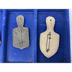 Twelve French military metal badges mounted on leather fobs including Legion, Artillery, Parachutist, Air Force, Infantry etc