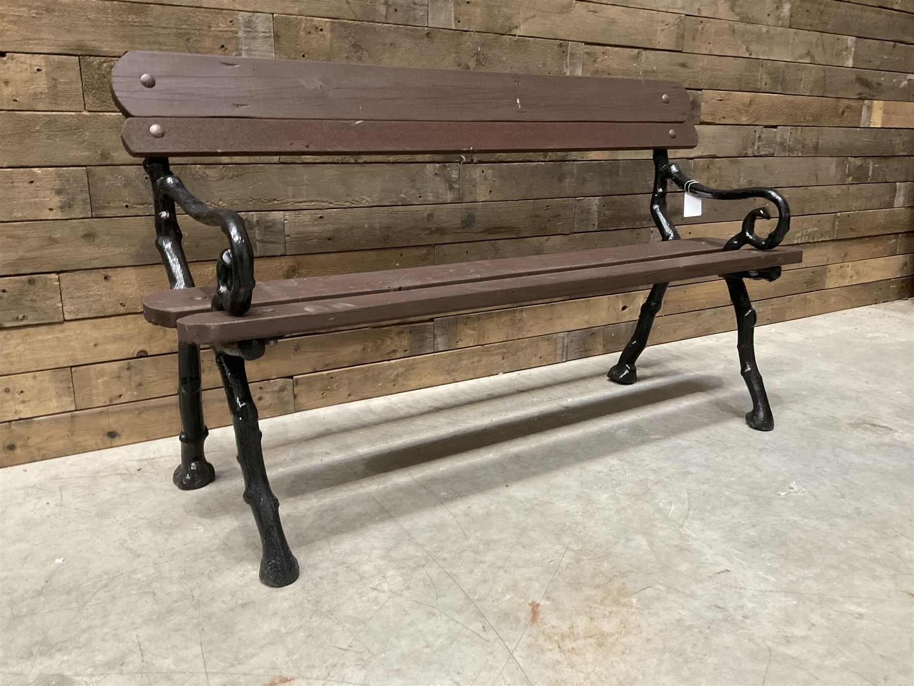 20th century tree cast iron and timber slatted garden bench, black painted frame with stained wood