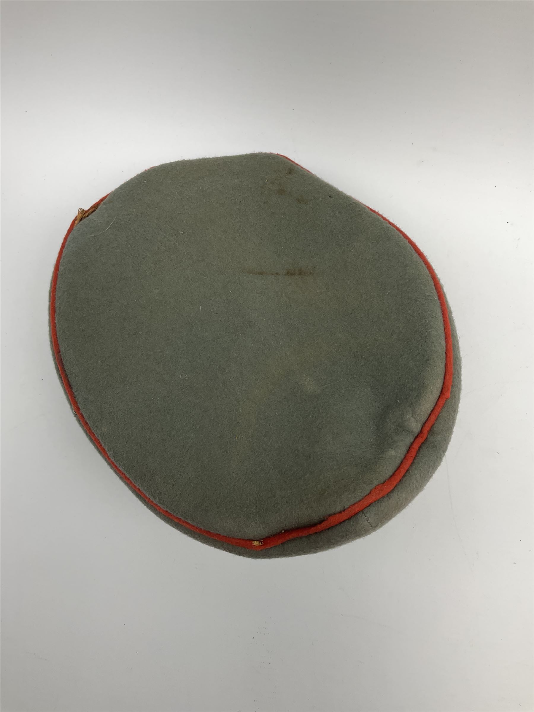 WW2 German Army Artillery officer's peaked cap, red piping to the crown and bordering the central band, zinc eagle and aluminium cockade insignia, officer's bullion chin cords, interior retains original sweatband and lining has tailor's celluloid diamond with 'Extra Klasse' logo and 'Marke Standard'