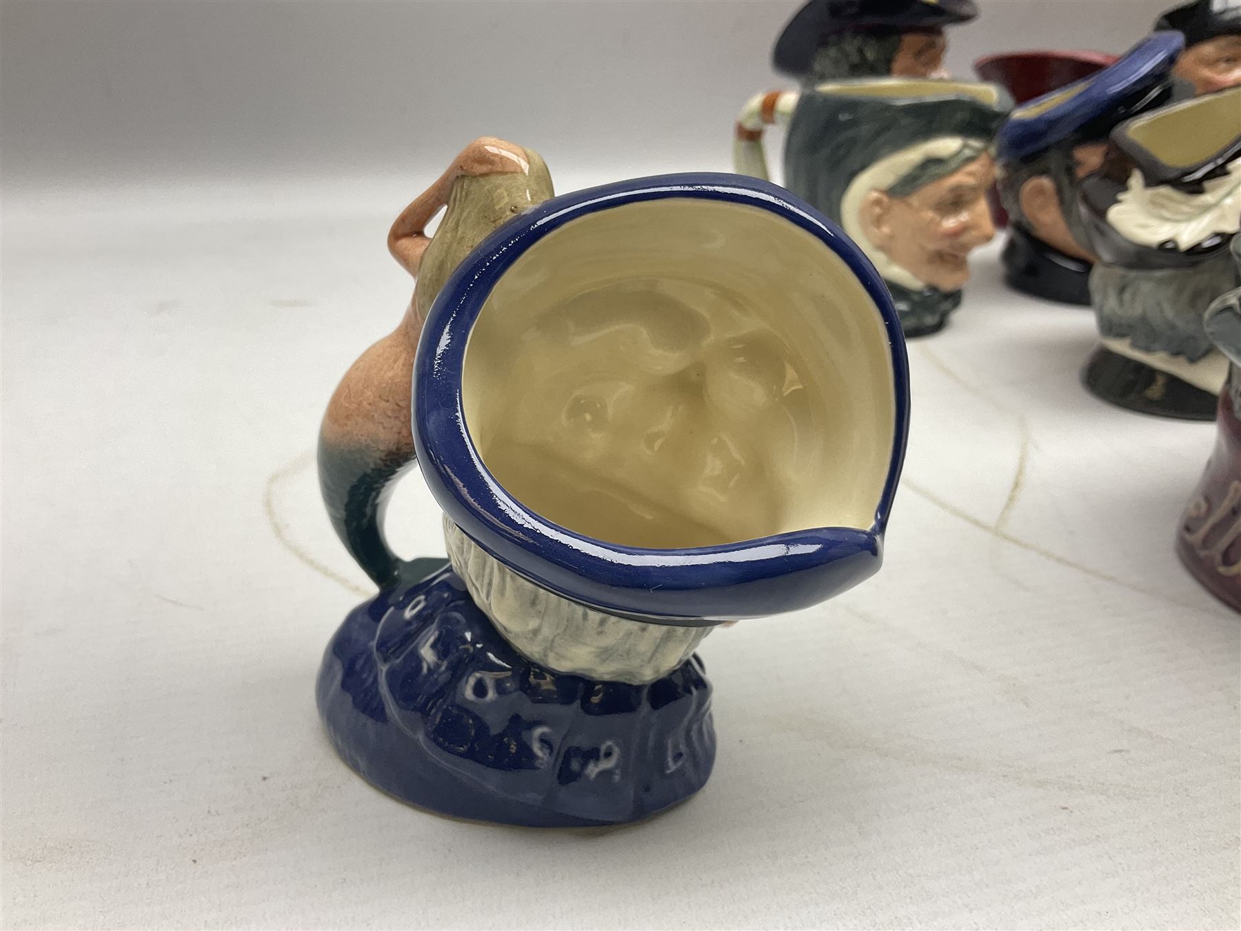 Large collection of Royal Doulton miniature character jugs, to include The Postman D6801, The London 'Bobby' D6762, Old Salt, D6554, Sir Henry Doulton D6703 etc  