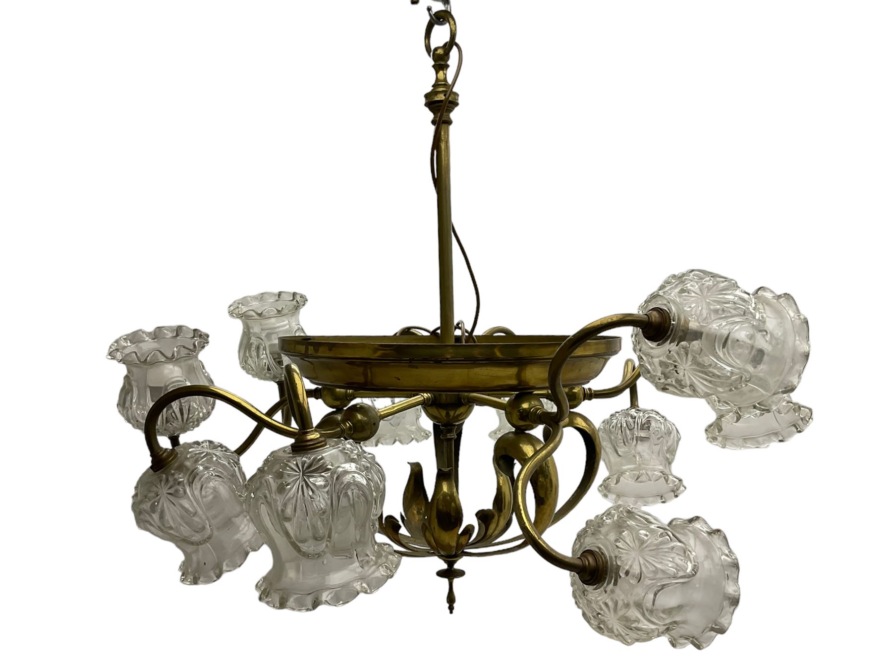 Mid-20th century brass lightolier or light fitting, the scrolling foliate branches connected with a central ring, terminating in ten tulip shaped cut glass sades, pointed terminal beneath