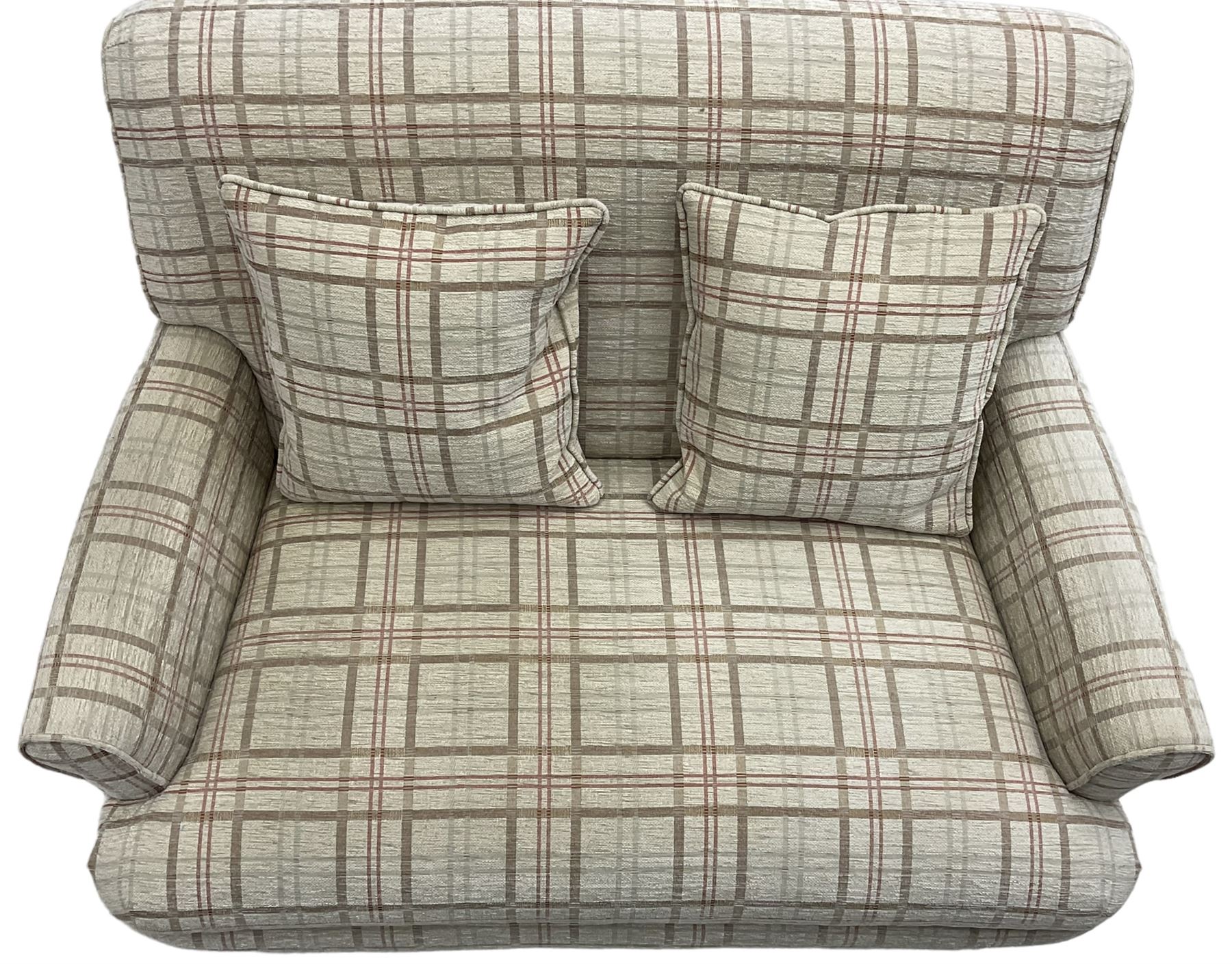 Traditionally shaped two-seat sofa, rolled back and arms, upholstered in checkered fabric, on turned front supports with brass cups and castors 