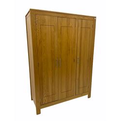 Oak triple wardrobe, fitted with hanging space and shelves 