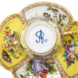 Two 19th century Dresden quatrefoil twin handled chocolate cups and saucers, decorated with Watteau style panels, with pink and yellow floral ground and gilt heightened decoration, blue 'AR' mark to underside for Helena Wolfsohn (2)