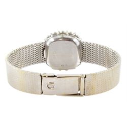 Omega ladies 18ct white gold quartz wristwatch, silvered dial with dot hour markers, round brilliant cut diamond bezel, hallmarked, on integral 18ct white gold bracelet, stamped 750
