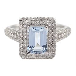 18ct white gold emerald cut aquamarine and diamond cluster ring, with diamond set shoulders, stamped K18, aquamarine 0.85 carat, total diamond weight 0.62 carat