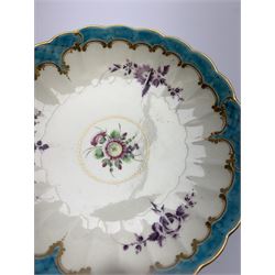 18th century Worcester teacup and saucer, circa 1775-1780, of fluted form hand painted with floral sprays in puce and further floral sprig to interior of cup and centre of saucer, within turquoise and gilt scroll borders, cup with remnants of paper label beneath, cup D8cm saucer D13.5cm