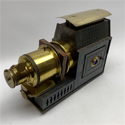 Victorian French brass and black japanned magic lantern inscribed  'Lanterne Depose C. & G. P. Universelle', with two hinged doors to the sides of the burner housing, L43cm (lacking burner)
