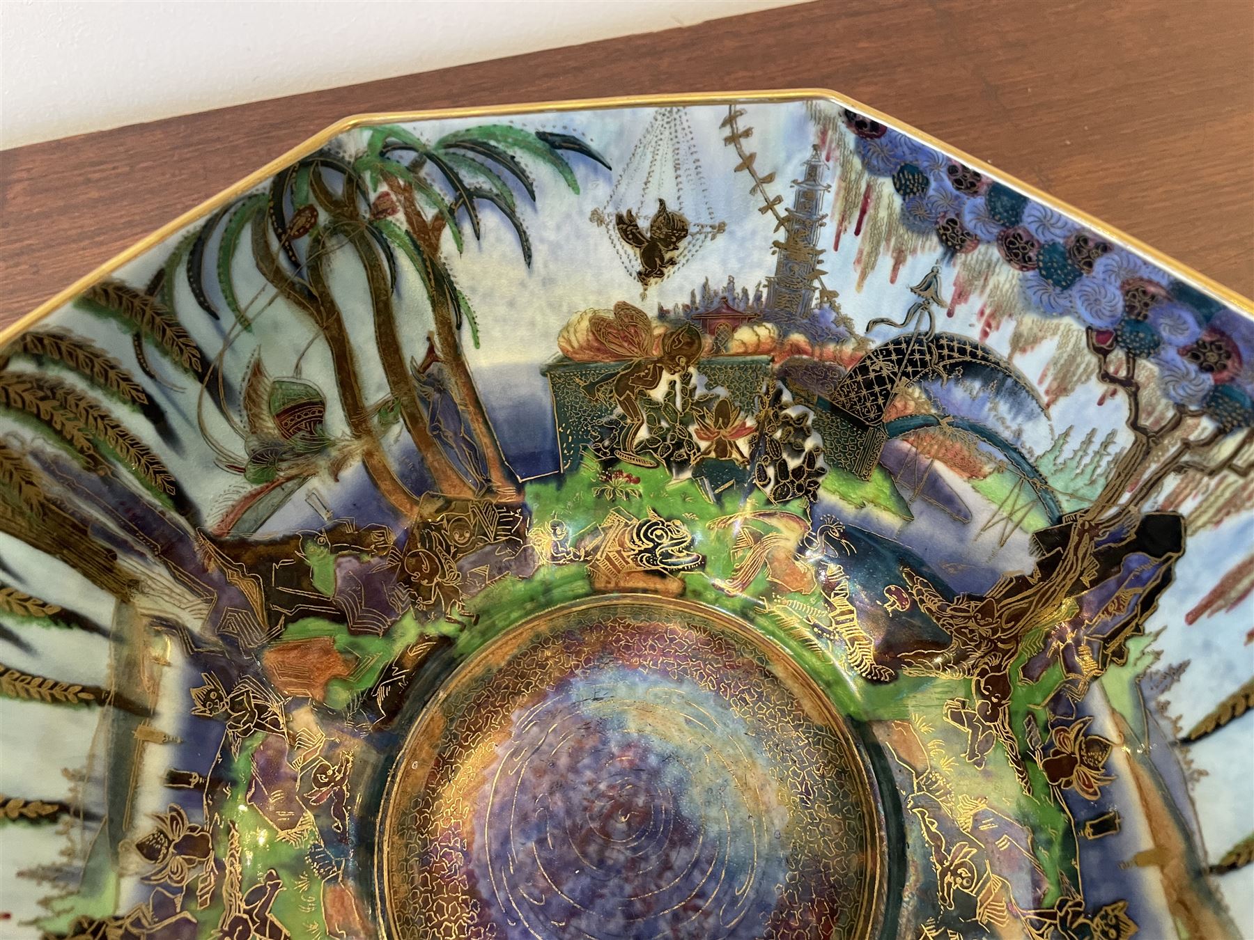 Early 20th century Wedgwood Fairland lustre bowl, circa 1920, of octagonal form, designed by Daisy Makeig-Jones, the exterior decorated in the Castle on the Road pattern, the interior decorated in the Fairy in a Cage pattern, pattern no Z5125, with printed marks beneath, H11cm D22.5cm
