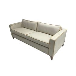 Neptune - pair three seat 'Shoreditch' sofas,  upholstered in cream fabric with yellow stringing