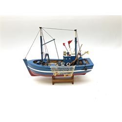 Wooden model of RMS Titanic, on a fixed black stand bearing plaque inscribed 'Titanic 1912', L54cm, H22cm, together with model of a sloop, gaff rigged on stand bearing plaque inscribed 'Sloop' L32cm, H42cm; and model of a fishing trawler on a stand bearing plaque inscribed 'Chalutier' L35cm, H28cm (3)