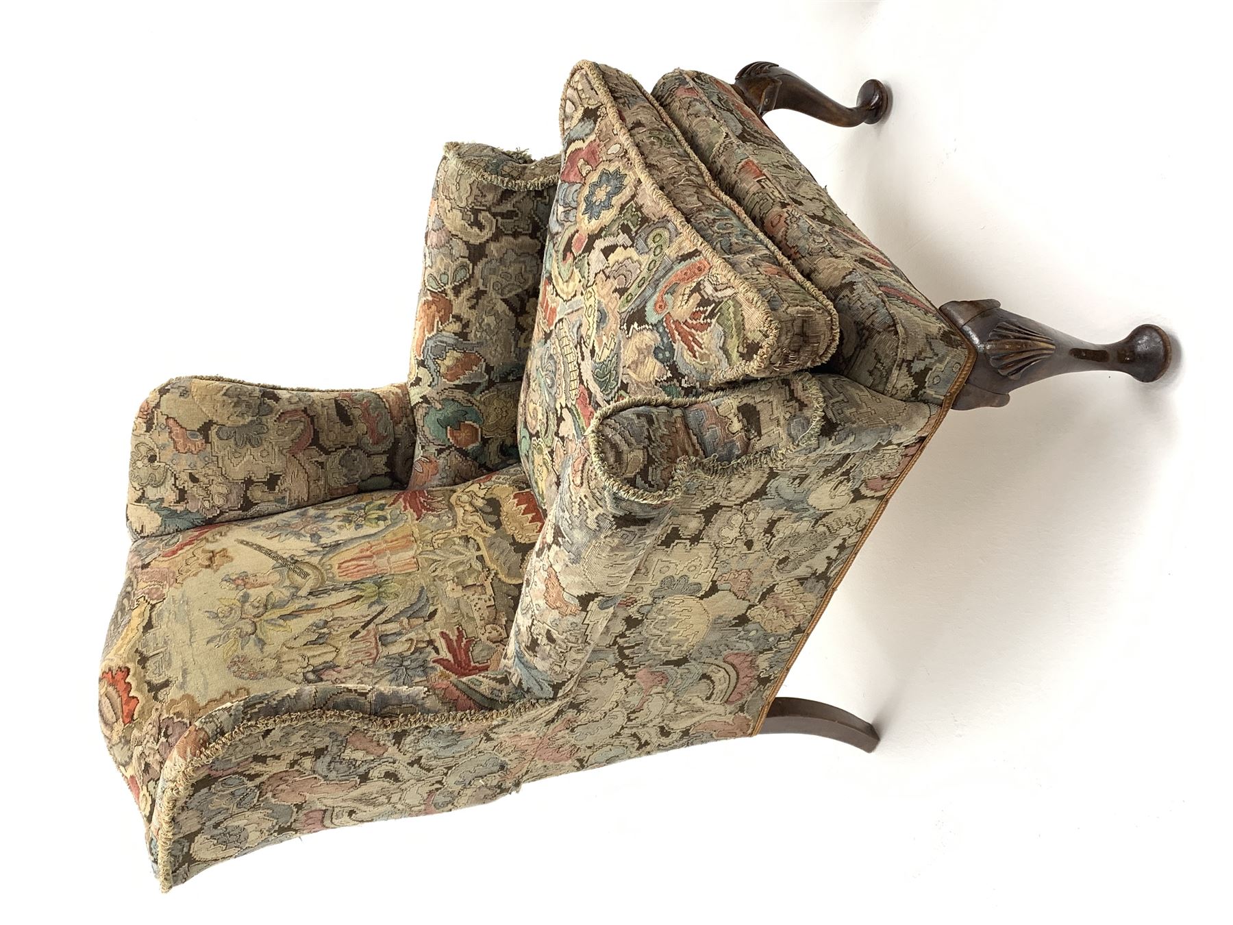 Matched pair early 20th century Queen Anne style wingback armchairs, walnut framed, sprung seats with seat cushions upholstered in needle work cover, shell carved cabriole front feet