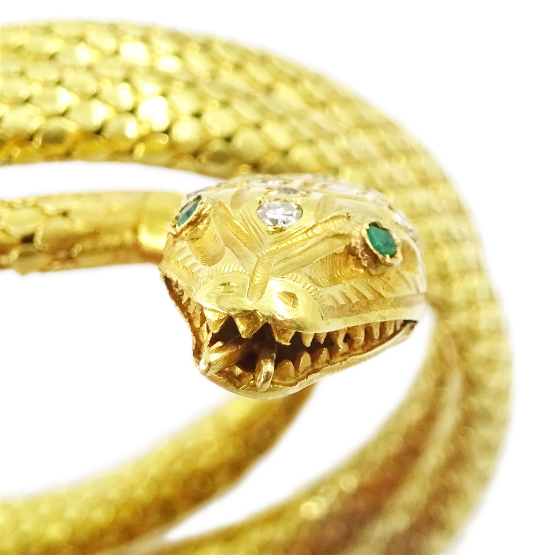 18ct gold coiled diamond snake bangle, the head set with round cut diamonds and emerald eyes, to an expanding articulated body, stamped Brevete S.G.D.G.