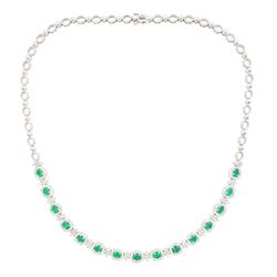 18ct white gold emerald and diamond necklace, fifteen oval cut emeralds, each surrounded b...