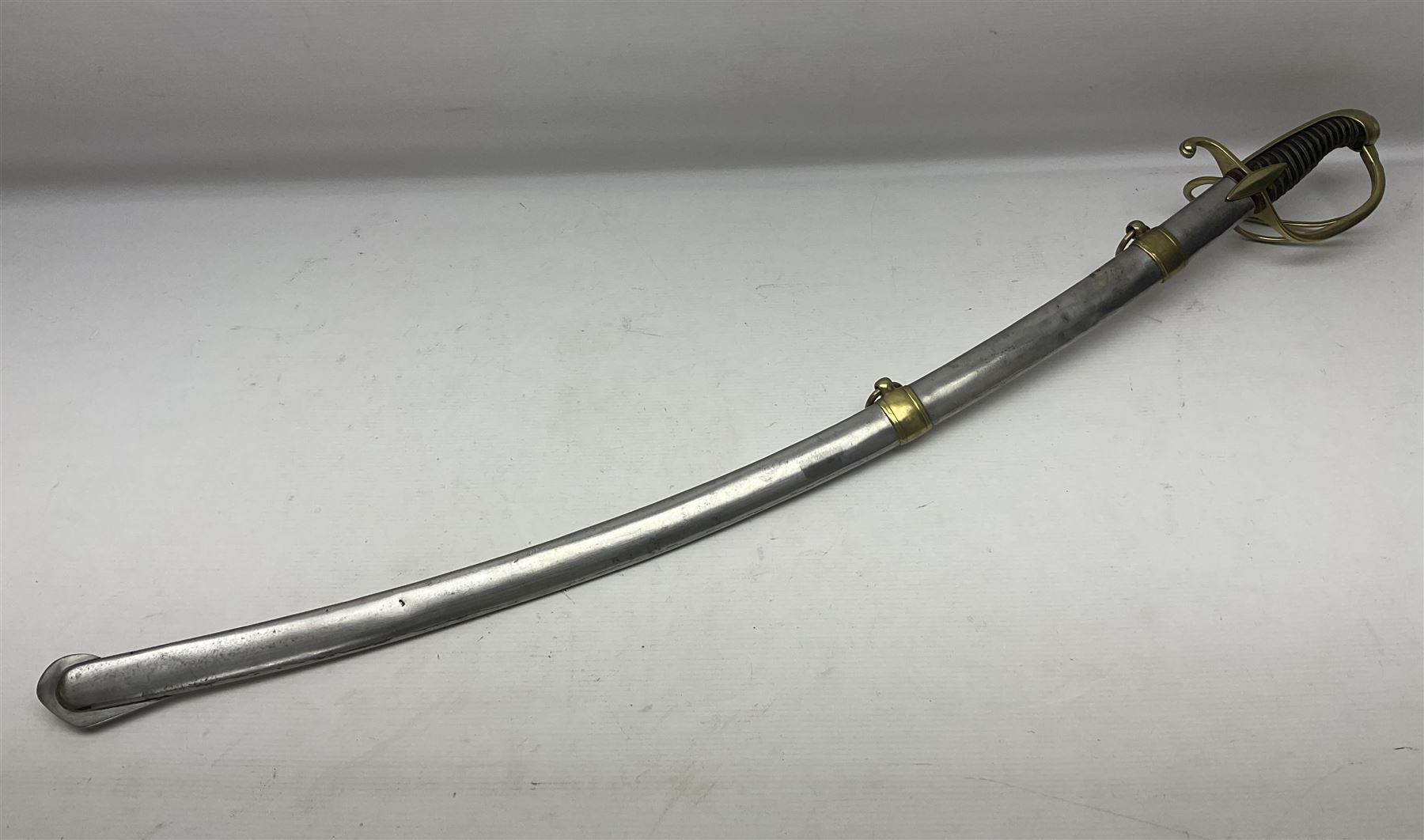 Early 19th century French Lancers officer's sword c1810, the 84cm curving fullered blade retaining most of its bluing, gilding and engraved decoration, inscribed I.S.& C. to ricasso (for Schimelbusch), brass three-bar hilt with elongated elliptical langets and wire-bound leather grip; in polished steel scabbard with two brass suspension rings L100cm overall