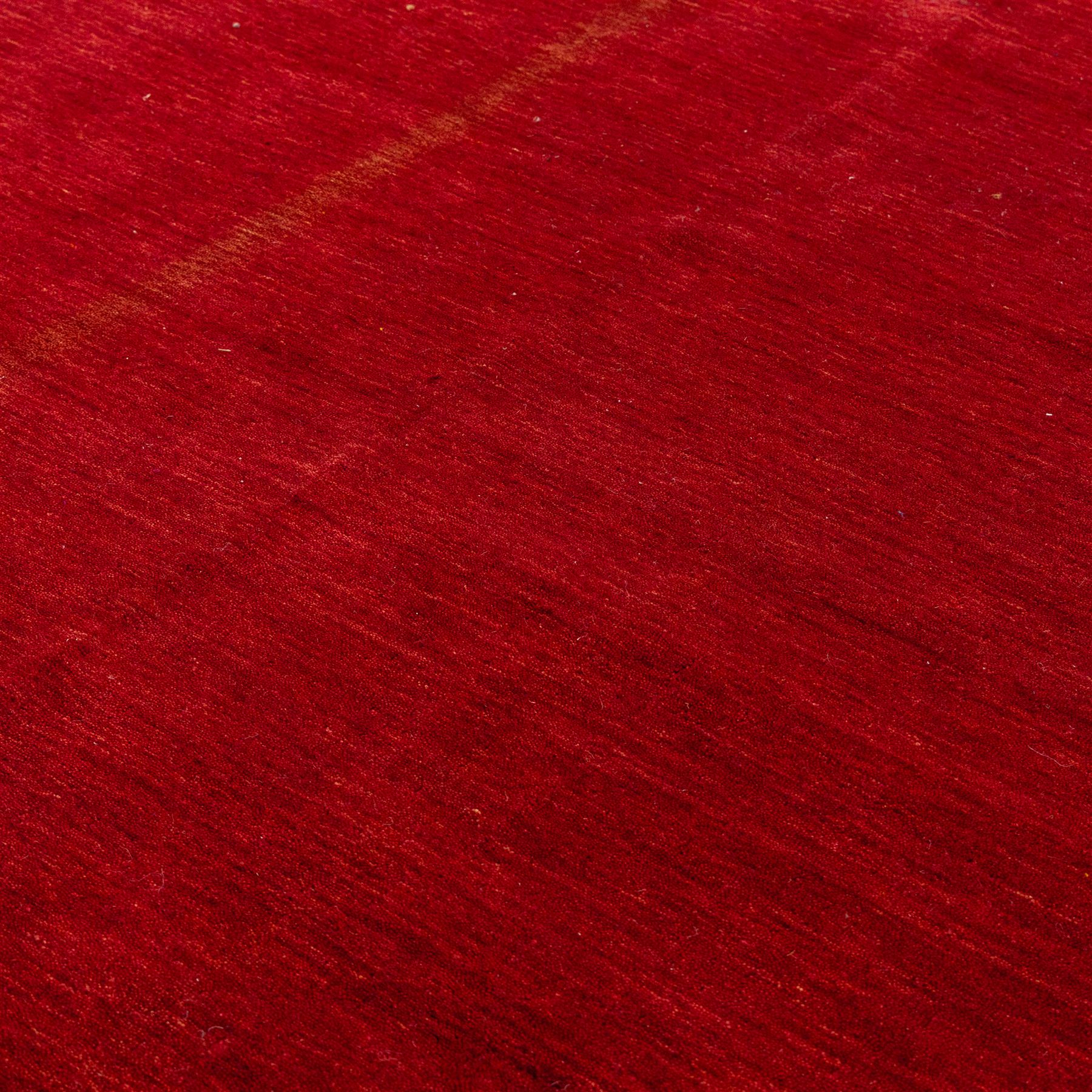 Two contemporary Moroccan Berber hand-woven rugs, deep madder red field of plain design, 199x153cm, other with deep madder red field with a simple lattice of ivory lines forming panels with some tonal variation, 190x146cm 