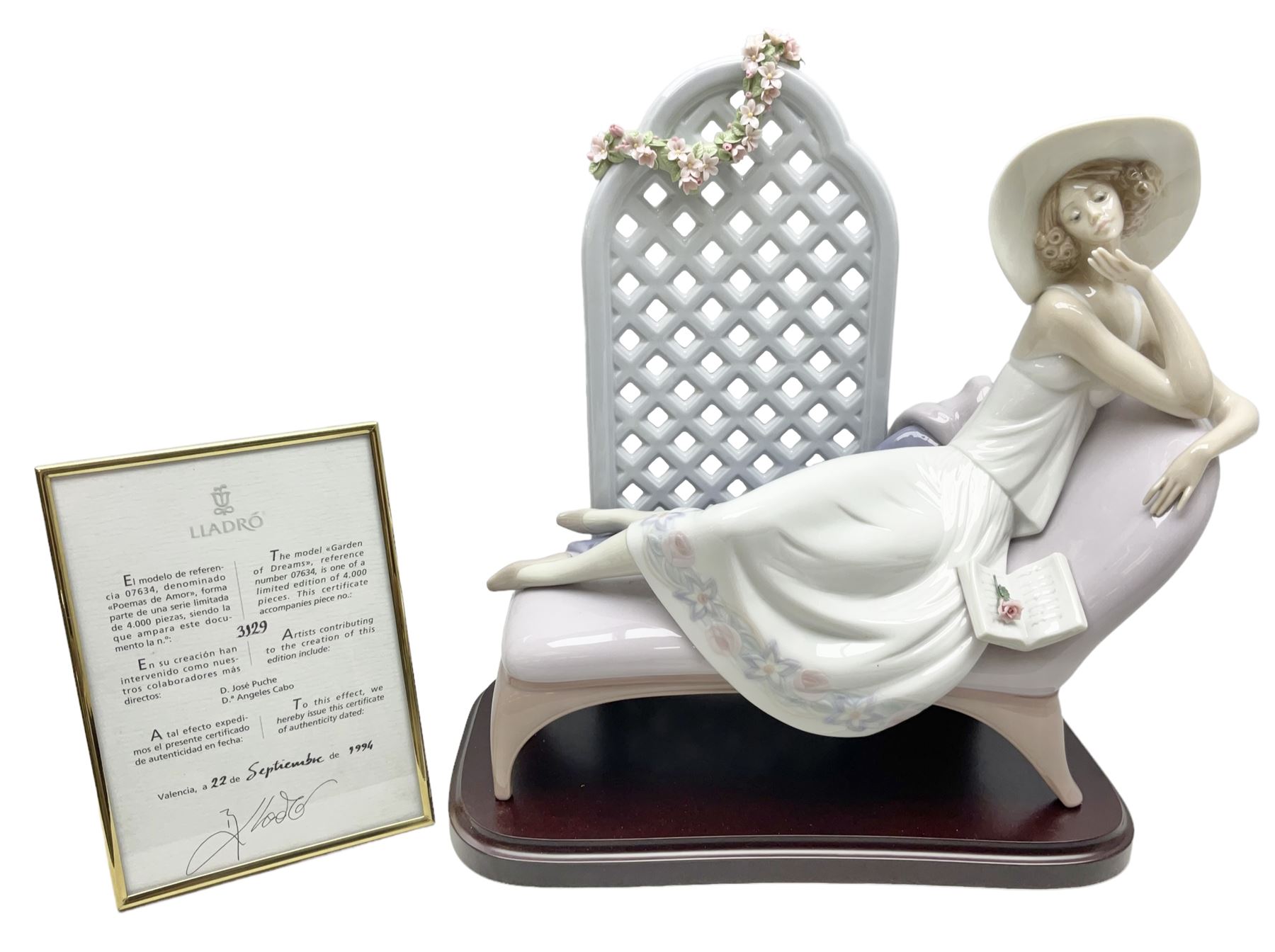 Lladro figure, Garden of Dreams, modelled as a woman reclining in front of trellis of flowers on a mahogany base, limited edition 3129/4000, sculpted by  José Puche, with original box, no 7634, year issued 1994, year retired 1996, H32cm