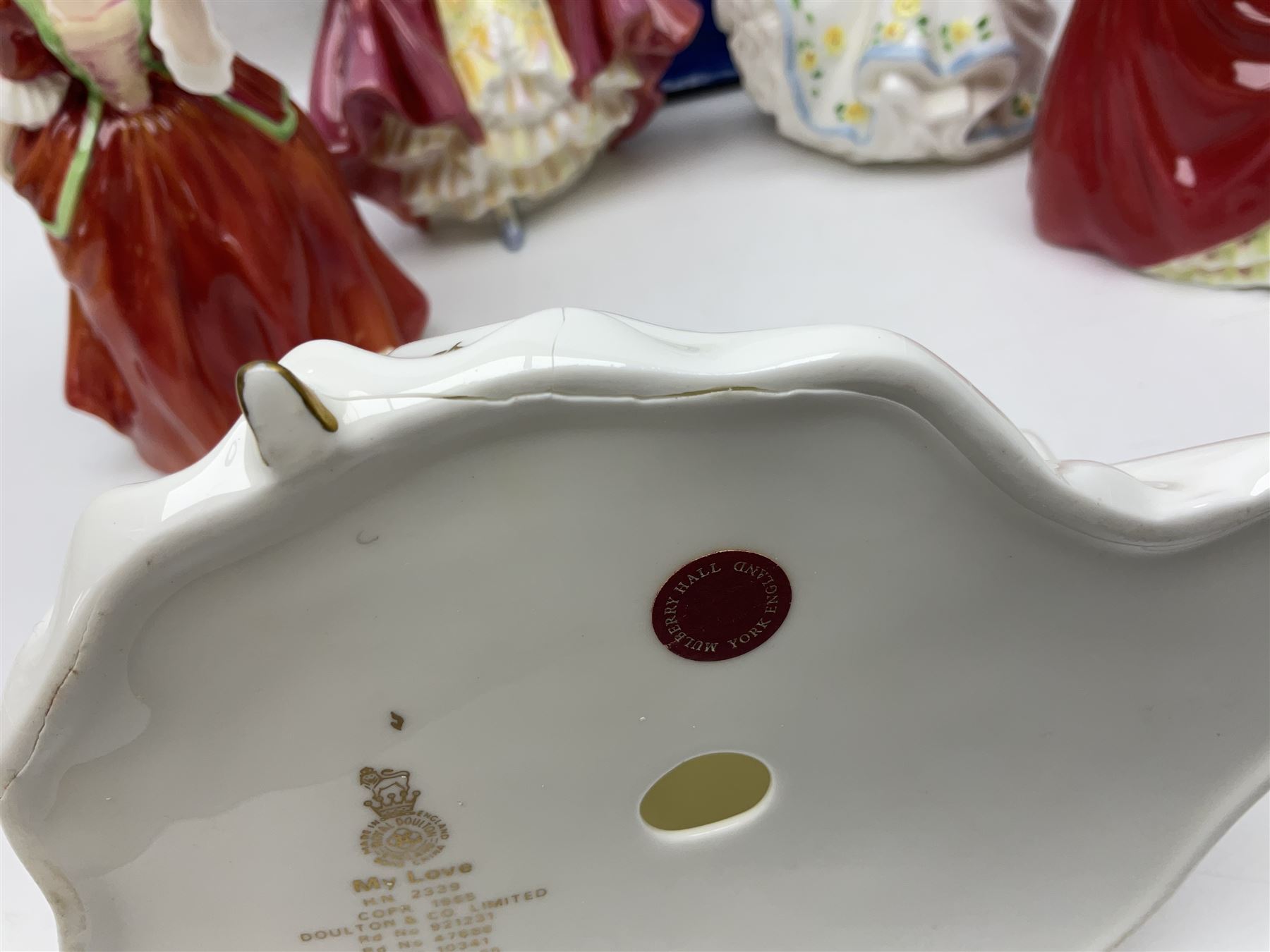 Five Royal Doulton figures, comprising Flower of Love HN3970, Emily HN3688, Southern Belle HN2229, Helen HN3886 and My Love HN2339, all with printed mark beneath, some with boxes, together with a Royal Doulton Figures reference book by D Eyles and R Dennis