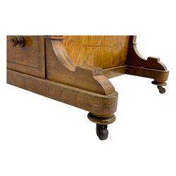 Early 19th century burr walnut Davenport desk, sloped leather-inset writing surface with brass gallery, fitted with an inkwell compartment and pen slot, four drawers to one side, raised on scrolled supports terminating in castors