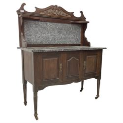 Late Victorian washstand, raised marble back with scroll and foliate carved pediment, rectangular top over three panelled cupboard doors, on turned supports with castors