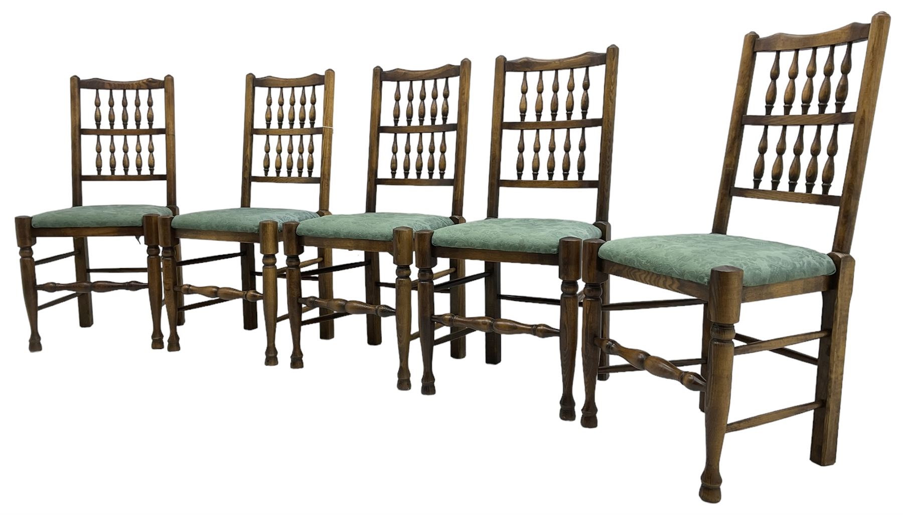 Set of five Lancashire design elm spindle back chairs, shaped cresting rail over two rows of five spindles, upholstered drop-on seats, on turned front supports united by turned stretchers  