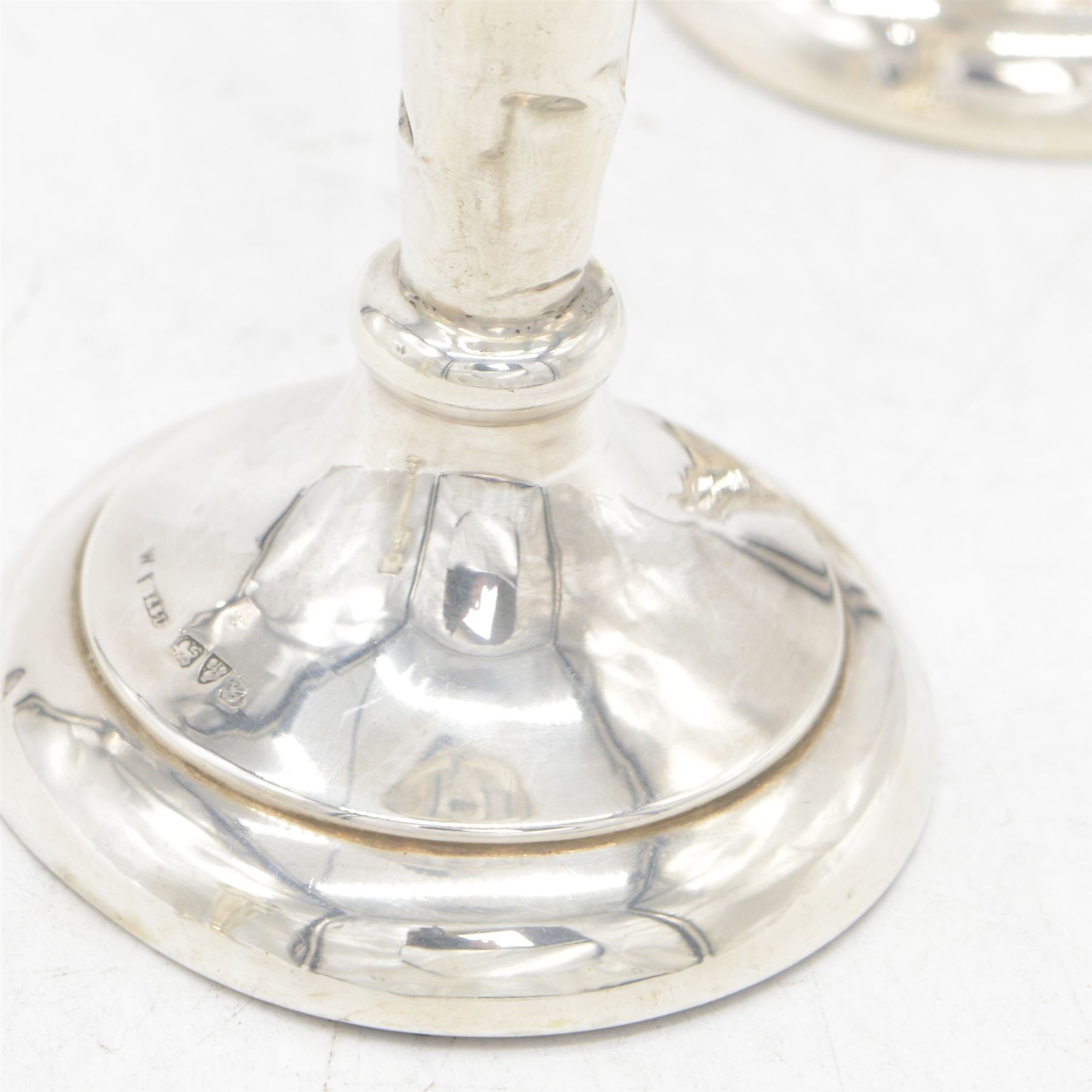 Two pairs of early 20th century silver vases, comprising pair of Edwardian trumpet vases with fluted rims upon a circular domed foot, hallmarked S Blanckensee & Son Ltd, Chester 1907, and a smaller 1920s pair, hallmarked Chester 1920, maker's mark worn and indistinct, tallest H19cm