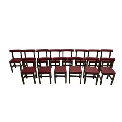 Set fifteen early 20th century oak school chairs, back rail and seat upholstered in claret red faux leather with studwork, raised on square supports united by H-stretcher (15)