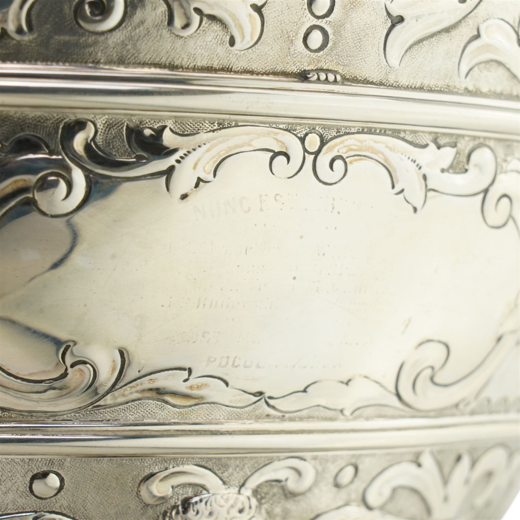 'Delwood Trophy in Memory of Col. H.H. Wilberforce' - A large Victorian silver rose bowl embossed with masks, wings, scrolls etc on a short pedestal foot D29cm London 1882 Maker Walter & John Barnard 