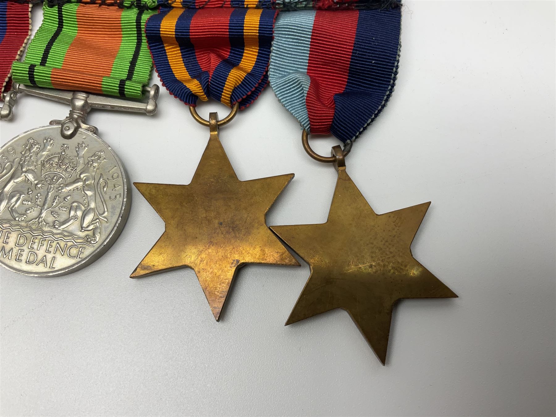 Collection of WW2 and police medals c.1933-1955, awarded to Eric Drinkwater comprising 1939-45 War Medal, Defence Medal, 1939-45 Star and Burma Star, on wearing bar; 1918-62 General Service Medal with Cyprus clasp to P.S. E.G. Drinkwater; boxed; Police Long Service and Good Conduct Medal to Const. Eric C. Drinkwater; cased; Royal Life Saving Society bronze medal to E.C. Drinkwater July 1933; boxed; and George V 1937 coronation medallion; boxed.