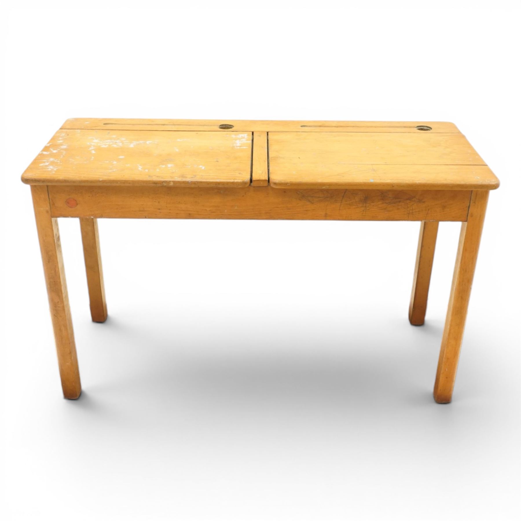 Mid-20th century beech double school desk, twin hinged desk-top compartments with inset pen and ink tray, on square supports