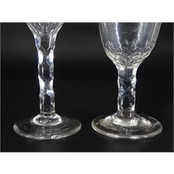 Two late 18th century drinking glasses, the ogee and rounded bowls with engraved and faceted borders, upon diamond faceted stems and conical feet, tallest H14cm