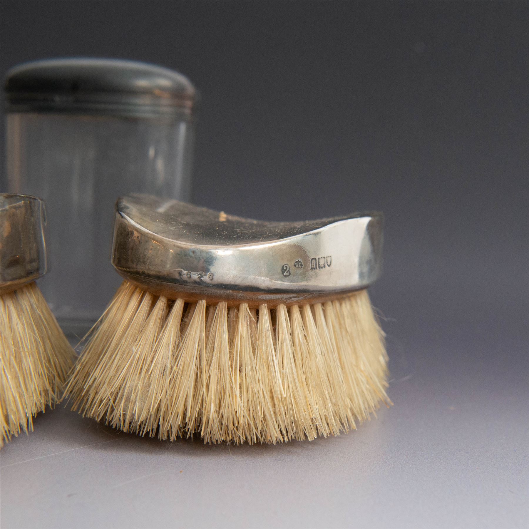 1920s gentleman's travelling case by Mappin & Webb Ltd, tan leather impressed with initials NAO, opening to reveal a compartmentalised interior containing silver mounted dressing table items, including a pair of silver mounted brushes, engraved NAO AMA 1918, hallmarked William Comyns, London 1911, five faceted glass jars and bottles with silver lids and a silver shaving brush holder, all hallmarked Mappin & Webb Ltd, London 1922, tan leather box containing razor, silver plated shoe horn, scissors and bevelled edge shaving mirror with easel support