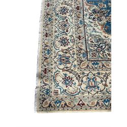 Persian Nain blue and ivory ground rug, wool with silk inlay, overall arabesque design, central medallion surrounded by interlacing and scrolled leafy branches and palmettes, the scrolling border decorated with stylised plant motifs, within guard stripes