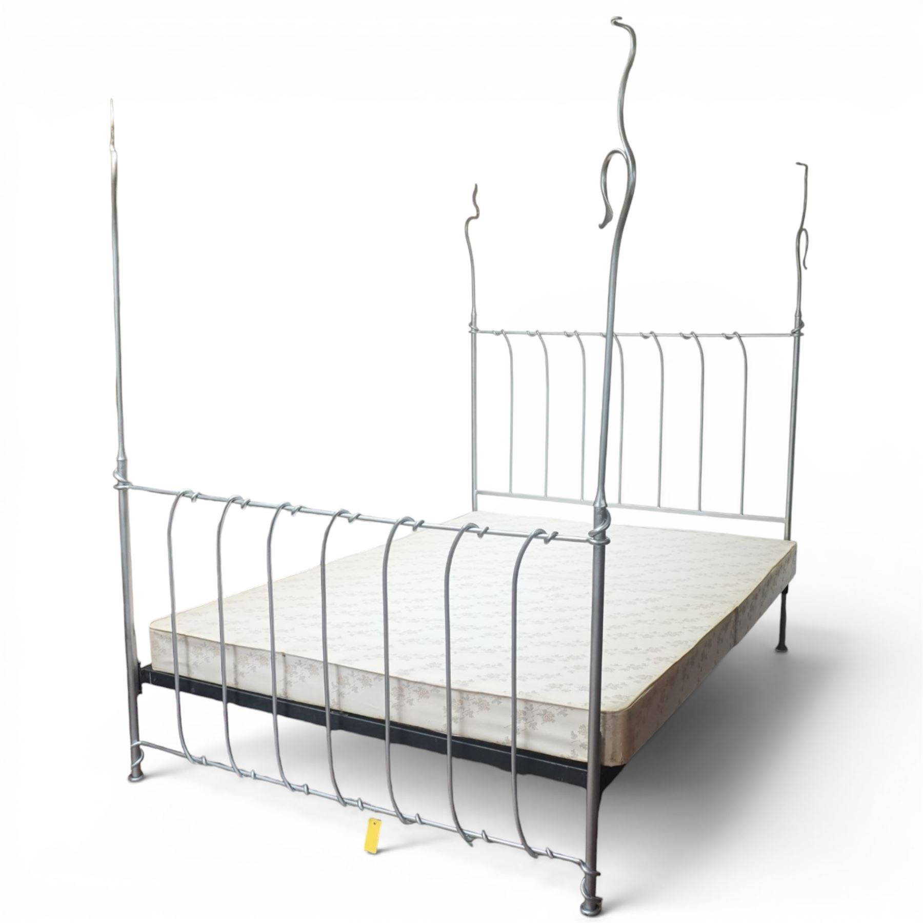 And So To Bed - 'Squigalina' silvered metal framed 5ft king size four poster bed, the tubular chrome posters in scrolling foliate form, over a shaped and scroll-topped metal spindle headboard and footboard
