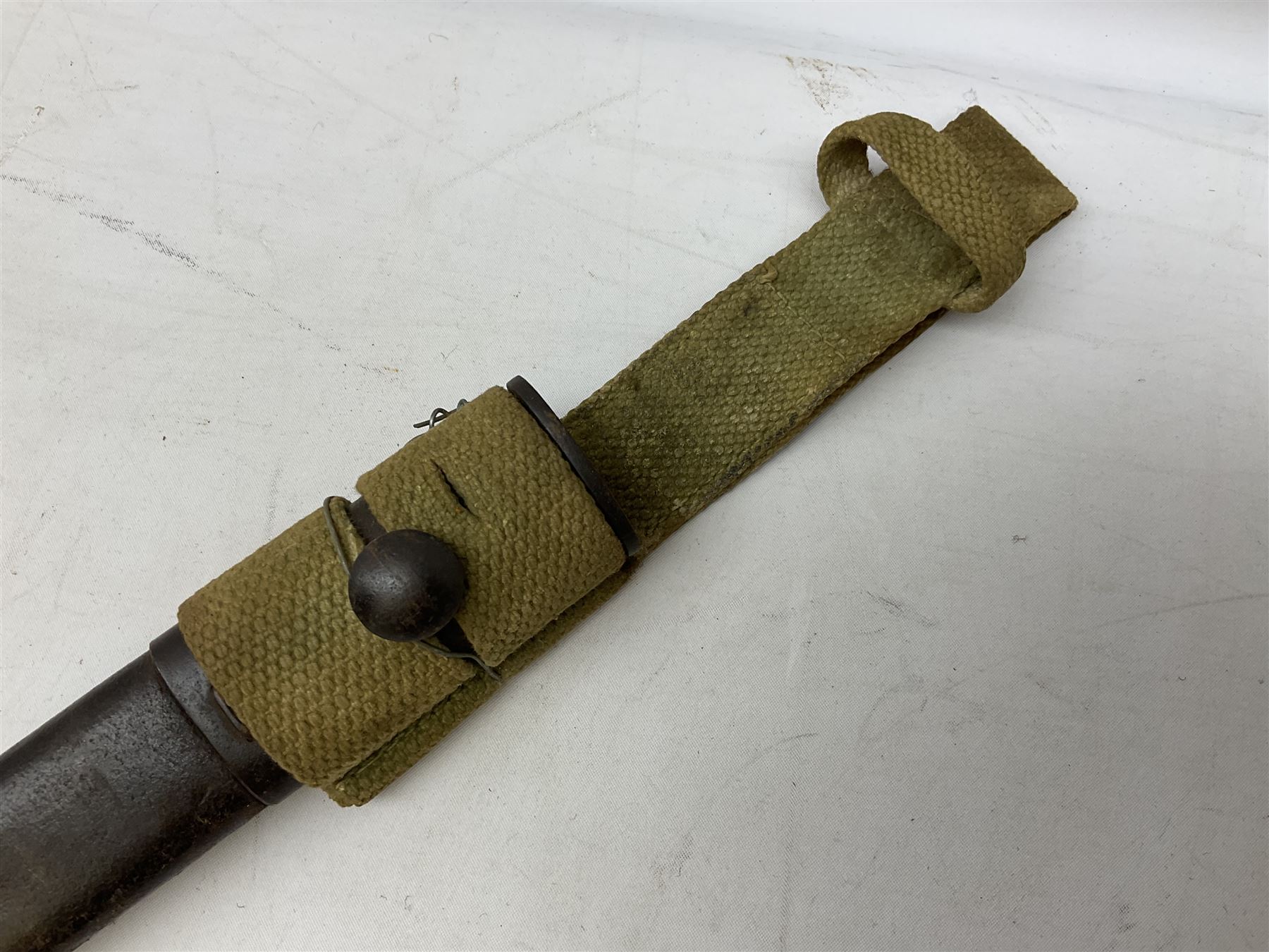 British Pattern 1907 bayonet with 43.5cm fullered steel blade; in leather scabbard with webbing frog L58cm overall; another Pattern 1907 bayonet lacking scabbard; and British Pattern 1888 Mk.I bayonet by Wilkinson London (no scabbard) (3)