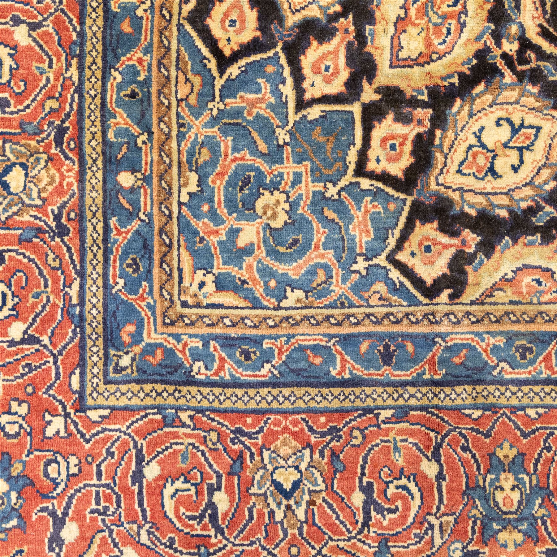Large North West Persian Mahal hand-knotted carpet, central indigo field with a rosette medallion with an all-over design of scrolling vines and palmettes, framed by a brick red border of arabesques and flowerheads between sky blue and ivory guard stripes, with cotton fringe ends 