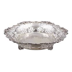 Modern silver Britannia standard fruit bowl, of lobed circular form, with applied and pierced fruiting vine decoration throughout, upon three bracket feet, hallmarked 1966, maker's mark BSC