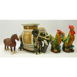  Beswick Shire horse 'Burnham Beauty' in matt brown glaze, L30cm, two Majolica type cockerels and a pottery elephant seat, H39cm (4)  