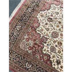 Finely knotted Persian Qom silk rug, overall pink ground with ivory field, the field with central cusped medallion profusely decorated with interlacing foliate and stylised flower heads, multiple band boarder, the main band decorated with a series of stylised motifs and trailing foliage, the outer guard with signature panel 