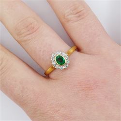 18ct gold emerald and diamond cluster ring, single oval cut emerald of approx 0.25 carat, surrounded by ten round brilliant cut diamonds, Birmingham 1995, total diamond weight approx 0.10 carat
