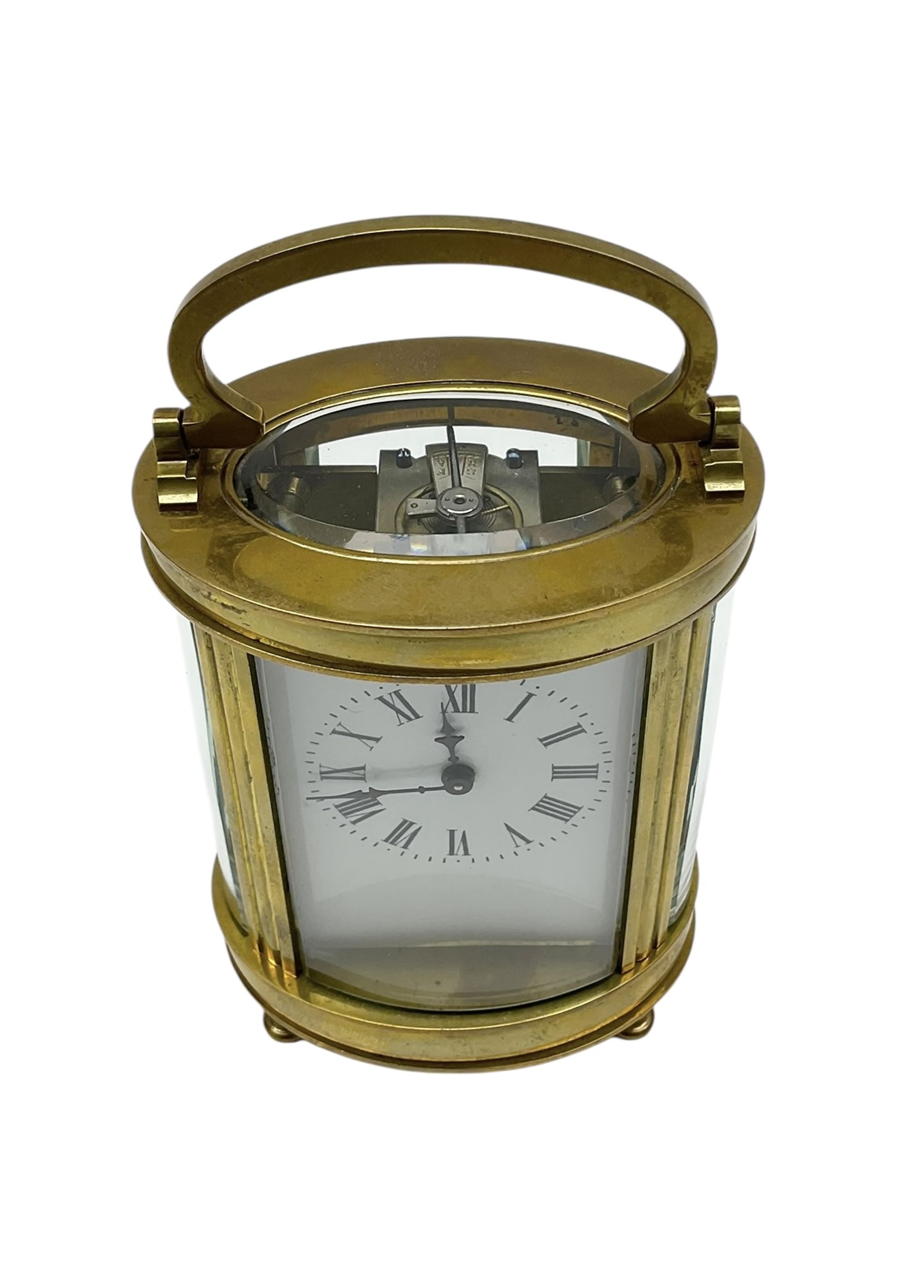 Two French early 20th century timepiece carriage clocks and a traveling case, both clocks with enamel dials, Roman numerals and steel hands, both with cylinder platform escapements.