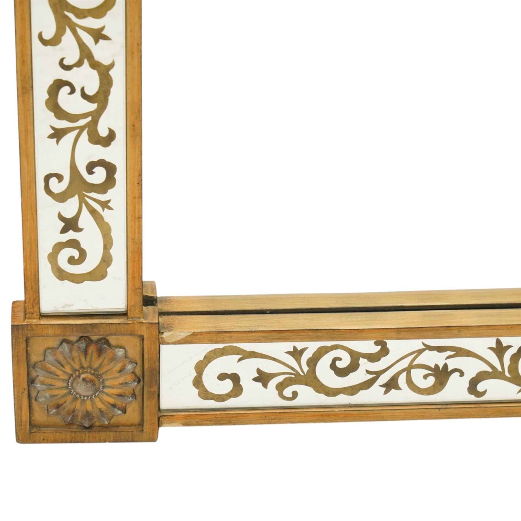 Regency inspired overmantel mirror, decorated with gilt foliate scrolls on the mirrored surrounds, flower and swag applied mounts