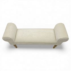 Contemporary upholstered window seat, rectangular padded seat with shallow scroll ends, upholstered in light cream fabric, raised on four turned wooden supports