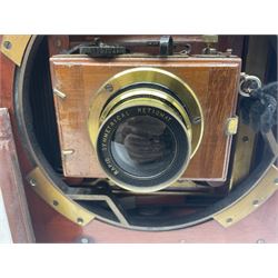 Folding plate camera in mahogany and lacquered brass, with Rapid Symmetrical Reetigmat len and two dark slides in canvas case
